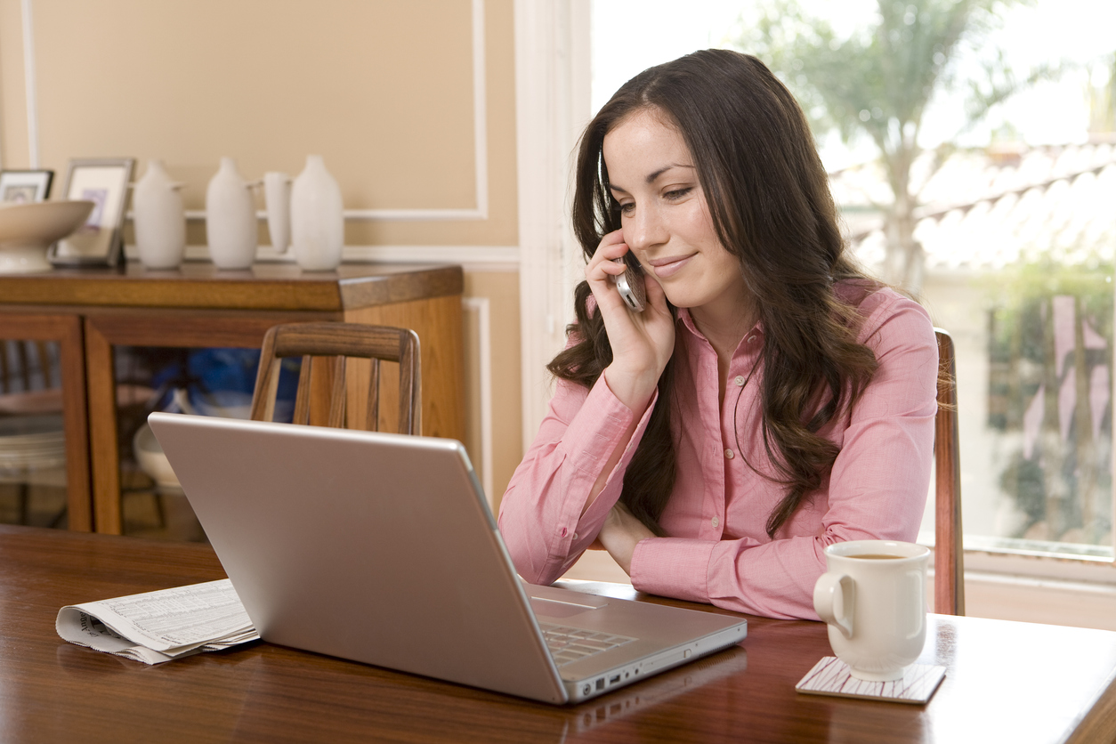 Talking on phone and looking at laptop.  View more: