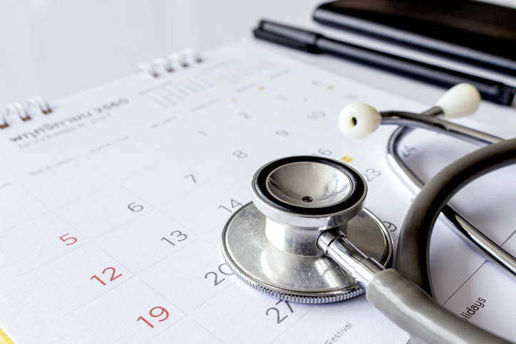 annual checkup concept. stethoscope on the calendar with soft-focus and over light in the background annual checkup concept. stethoscope on the calendar with soft-focus and over light in the background